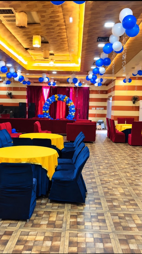 Banquet hall with balloon ring arch, cove ceiling, and dining setup at Shah Junction